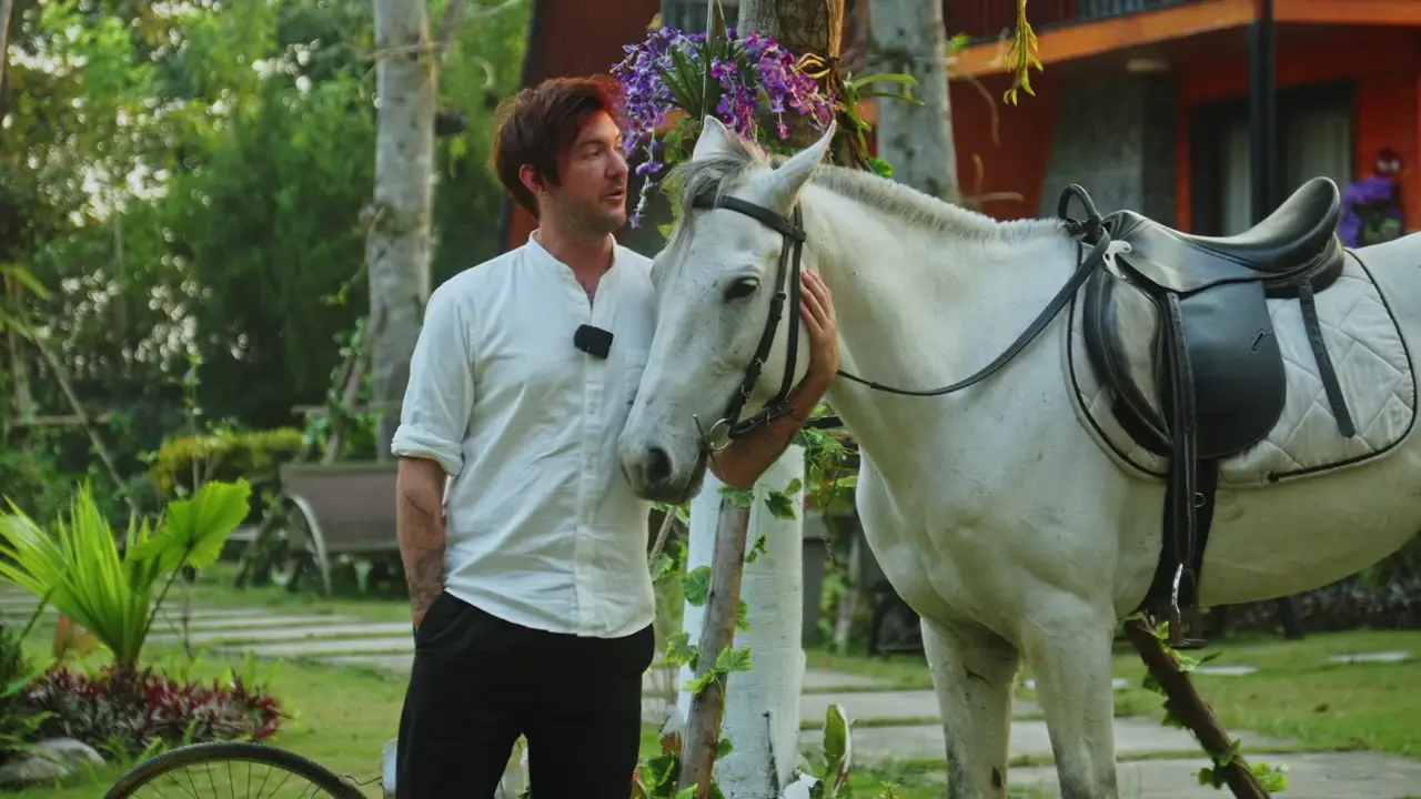 Carl beside a horse during the countryside riding experience near Hanoi